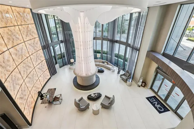 a table and chairs in the floor and a living room view