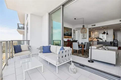 a living room with furniture and a book shelf