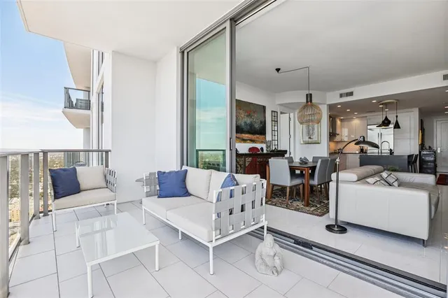 a living room with furniture and a book shelf