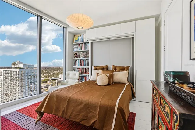a view of a tall building with swimming pool and sitting area
