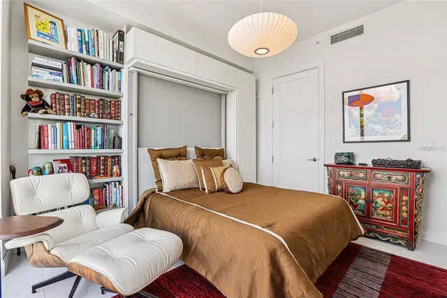 a view of a patio with couches table and chairs and wooden fence