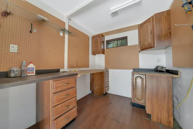 a view of a house with a yard and wooden deck