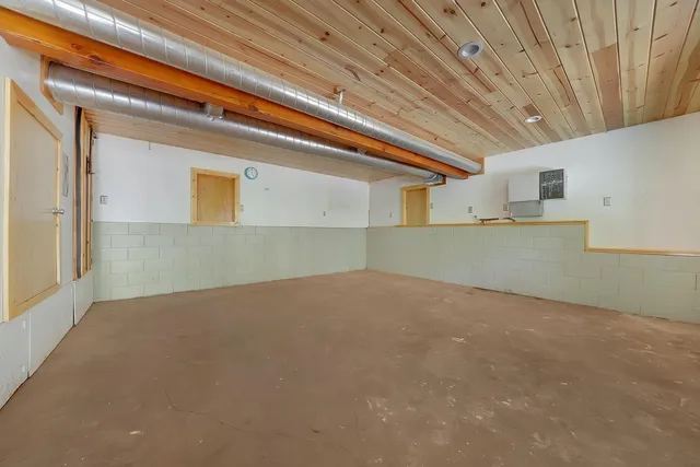 an aerial view of a house with a yard and large tree