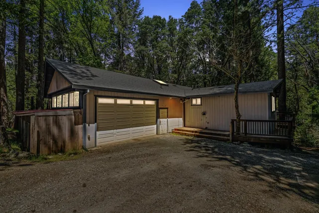 a large kitchen with stainless steel appliances a large counter top a stove and a chandelier