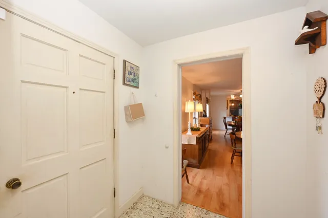 a view of a dining room with furniture a chandelier and wooden floor