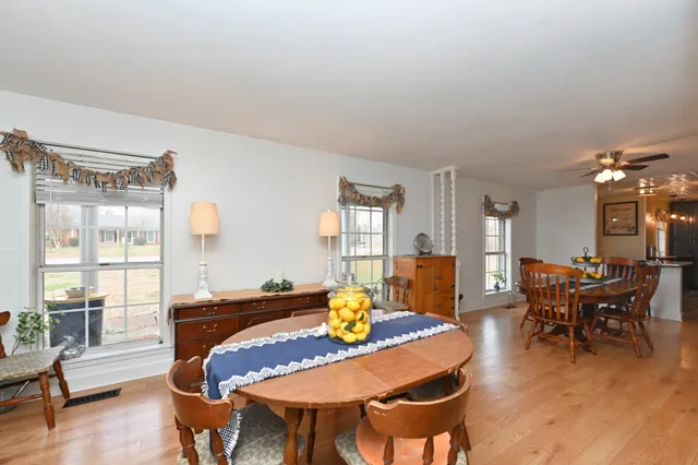 a kitchen with stainless steel appliances a refrigerator a stove a sink dishwasher and wooden cabinets with wooden floor