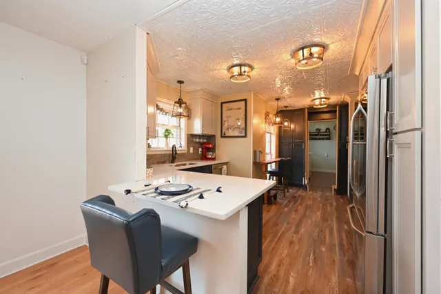 a kitchen with a refrigerator and a sink