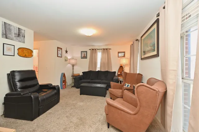 a bedroom with a bed and dresser with mirror