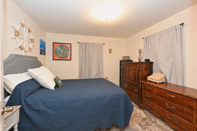 a bedroom with a bed and a mirror