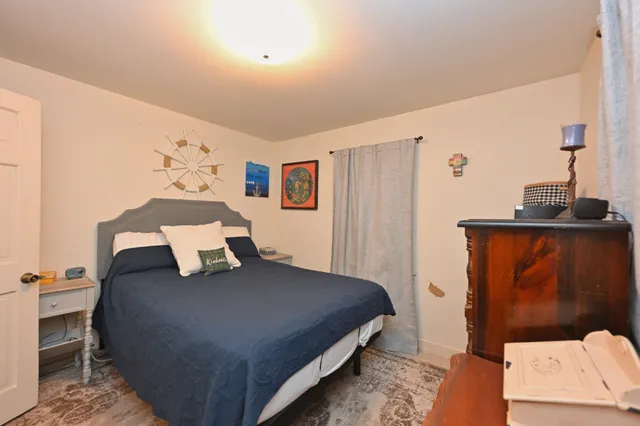 a bedroom with a bed closet and mirror