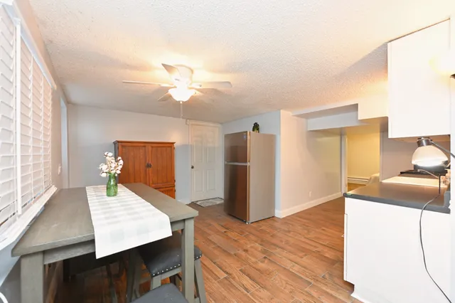a view of a lake with lawn chairs under an umbrella