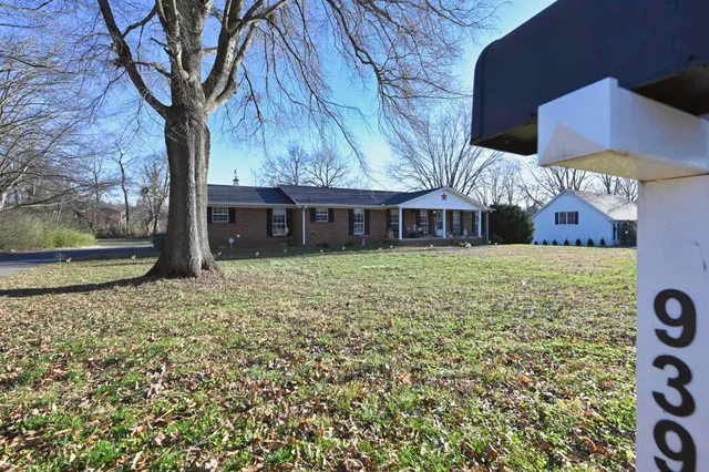 a living room with furniture a rug and a chandelier