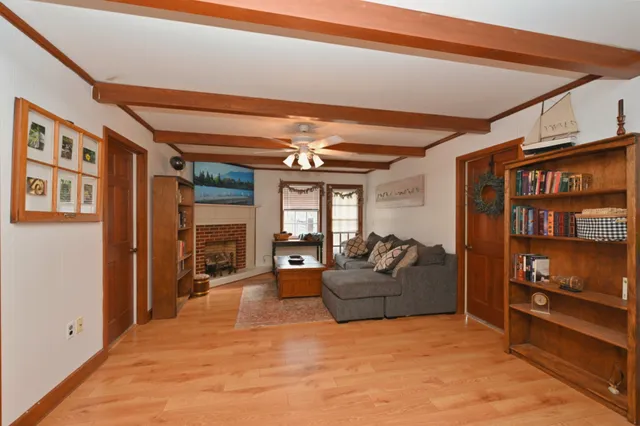 a living room with furniture a fireplace and a floor to ceiling window