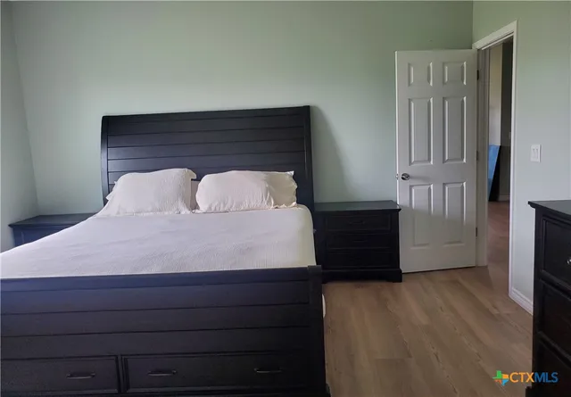 a bedroom with a bed and a dresser
