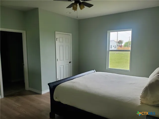 a bedroom with a bed and a window