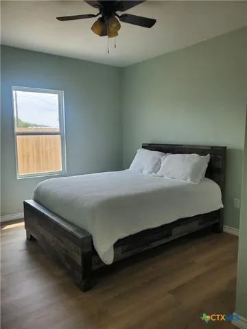 a bedroom with a bed and window