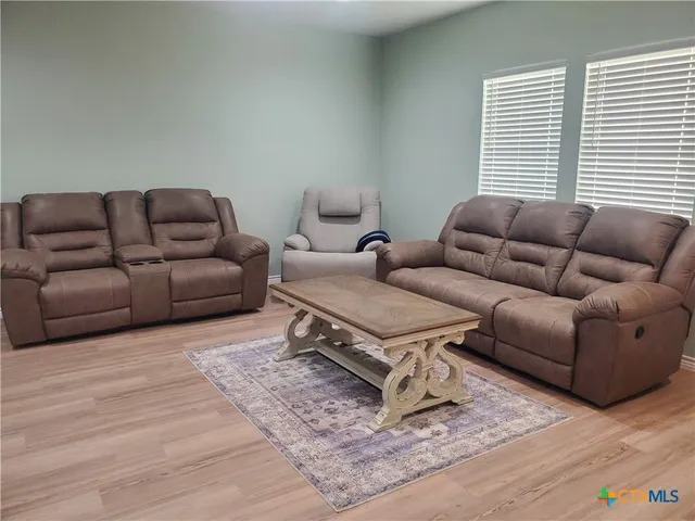 a living room with furniture and a window