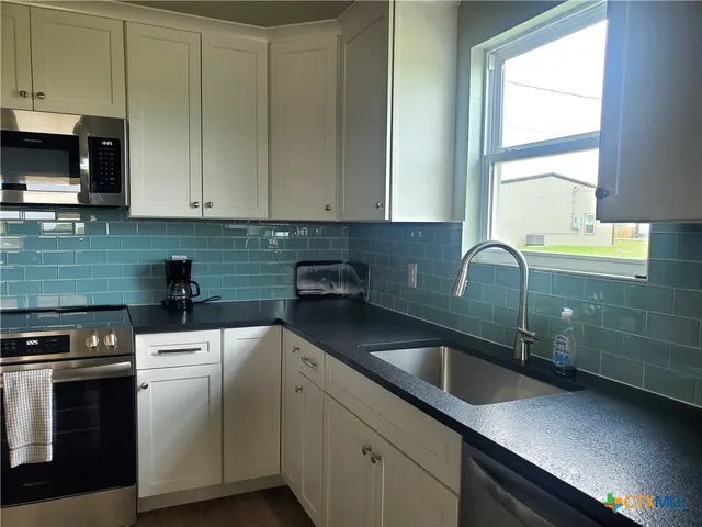a kitchen with a sink and cabinets