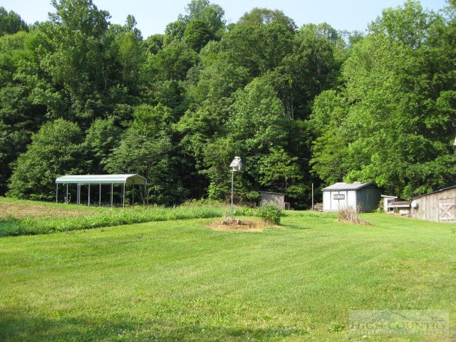 1535 Dark Ridge Road Elk Park, NC 28622 - Photo 3 of 8 a view of a house with a yard and sitting area