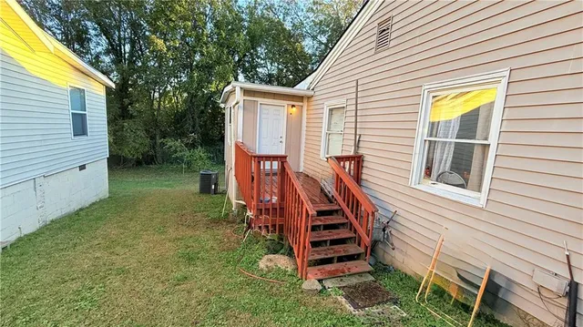 a view of a house with backyard and a trees