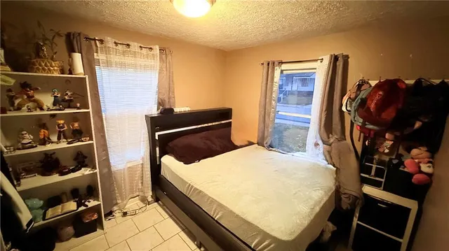 a bed room with a bed and a window