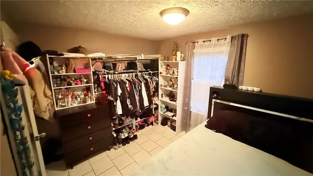a view of walk in closet with clothes
