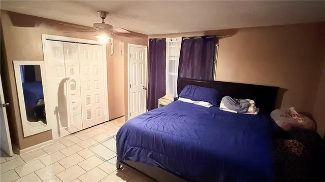 a bedroom with a bed and a walk in closet