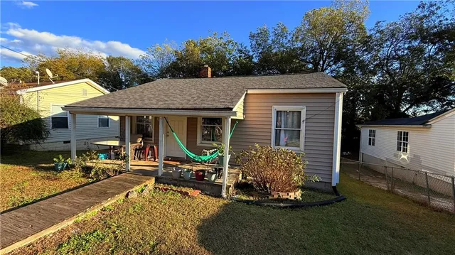 a view of house with yard outdoor seating area