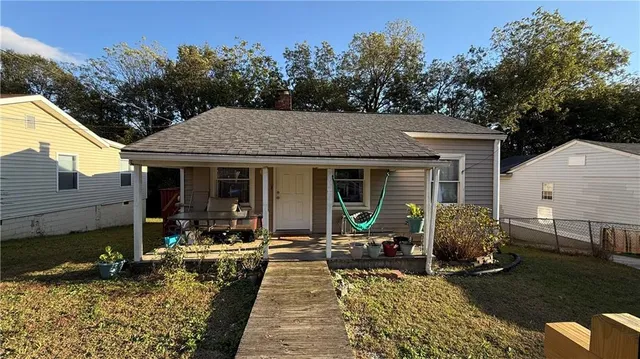 a view of a house with backyard sitting area and garden