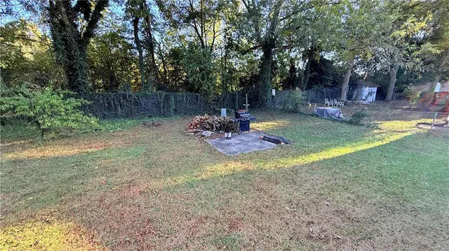 a backyard of a house with yard and trampoline