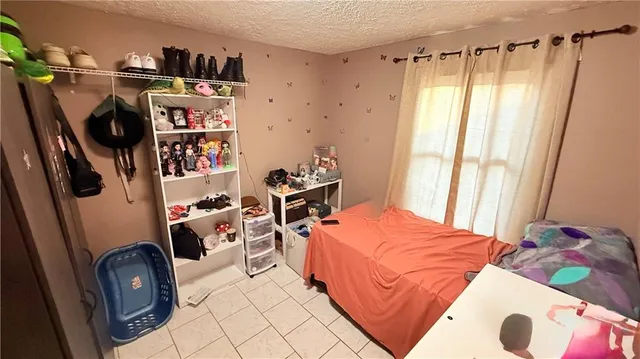 a bedroom with furniture and a book shelf