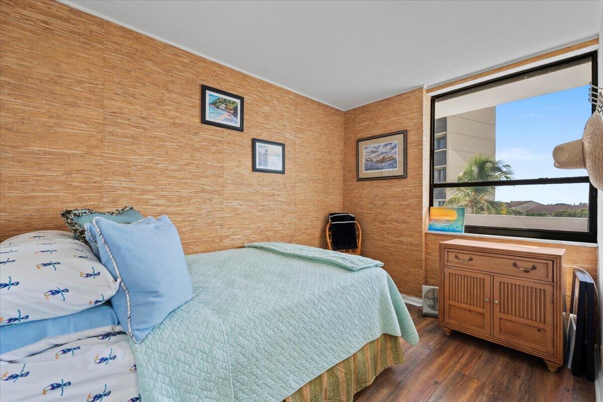 1200 Marine Way, Unit 304 North Palm Beach, FL 33408 - Photo 11 of 31 a bedroom with a bed and wooden floor