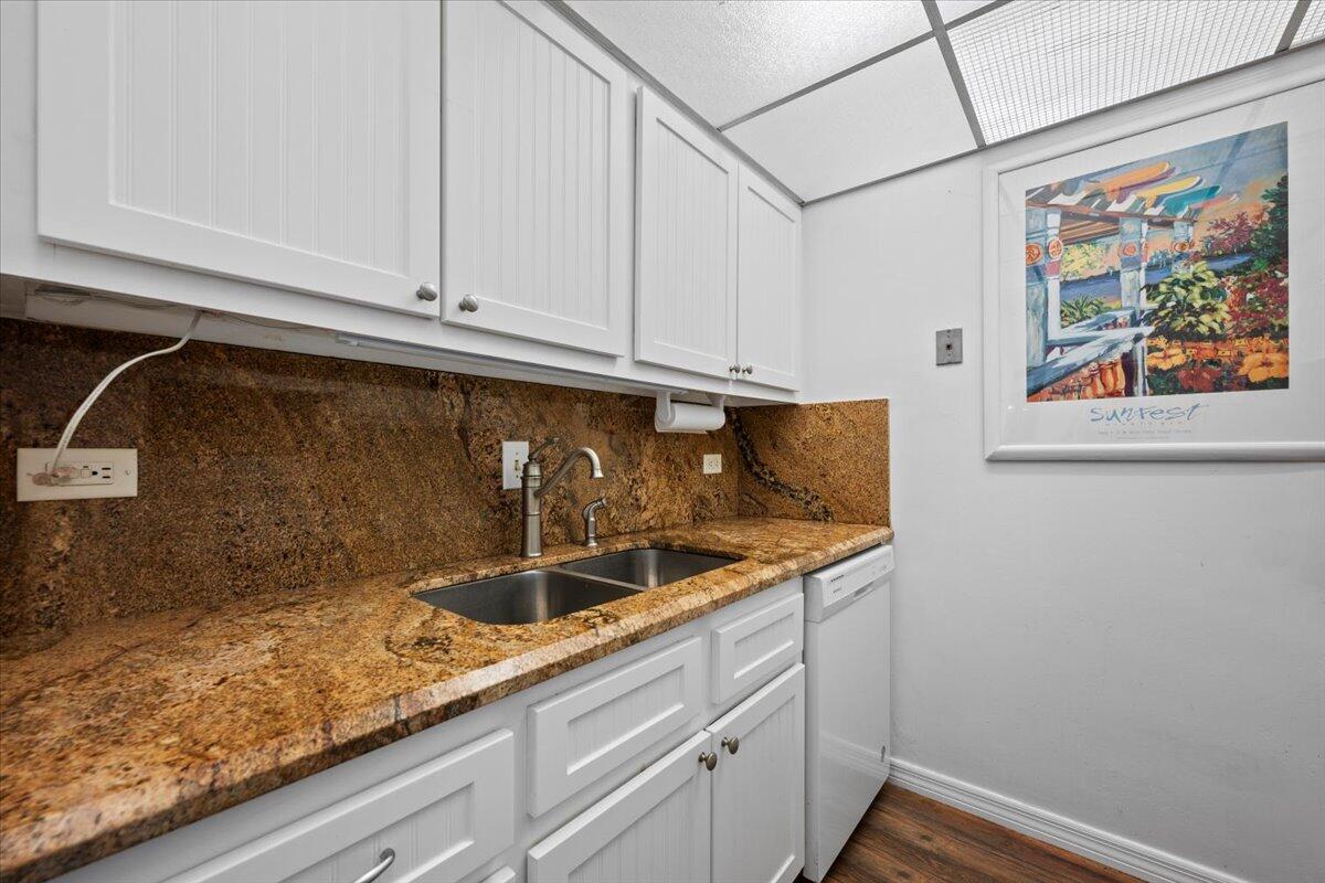 1200 Marine Way, Unit 304 North Palm Beach, FL 33408 - Photo 12 of 31 a kitchen with granite countertop white cabinets and sink