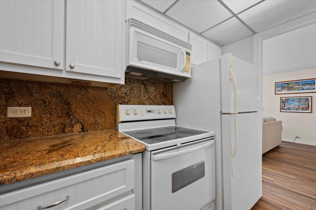 1200 Marine Way, Unit 304 North Palm Beach, FL 33408 - Photo 13 of 31 a kitchen with white cabinets and white appliances