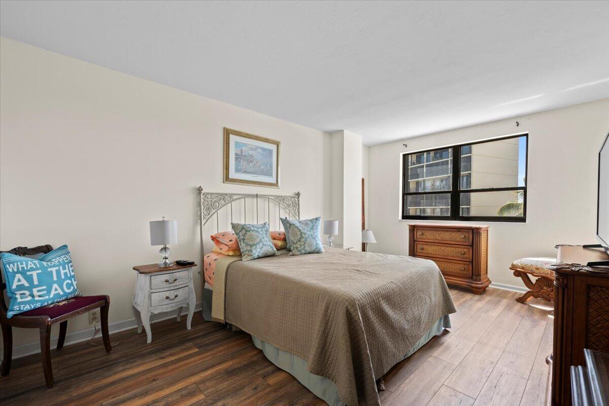 1200 Marine Way, Unit 304 North Palm Beach, FL 33408 - Photo 14 of 31 a bedroom with a bed and wooden floor