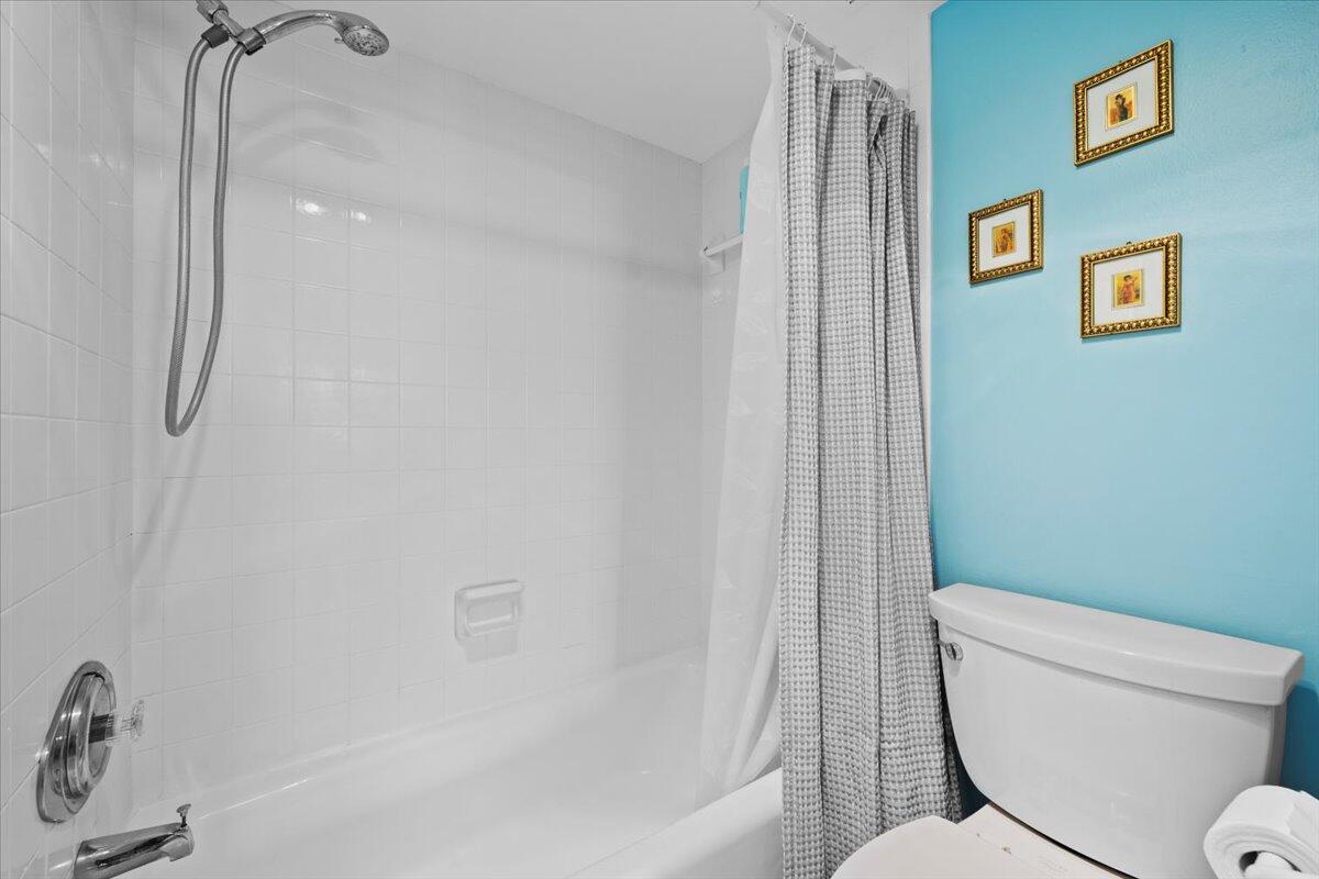 1200 Marine Way, Unit 304 North Palm Beach, FL 33408 - Photo 17 of 31 a white toilet sitting next to a bath tub