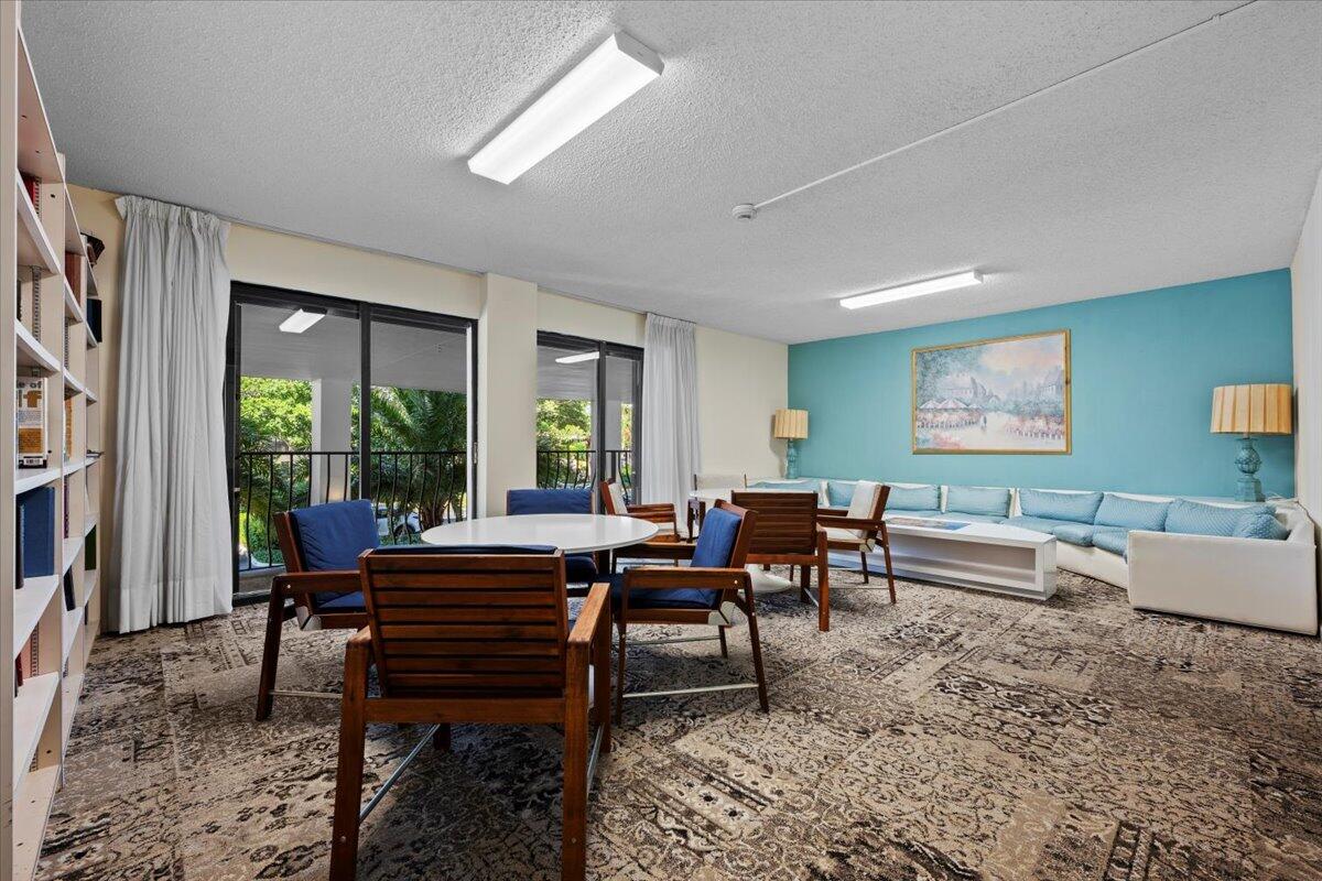 1200 Marine Way, Unit 304 North Palm Beach, FL 33408 - Photo 20 of 31 a living room with furniture and a large window