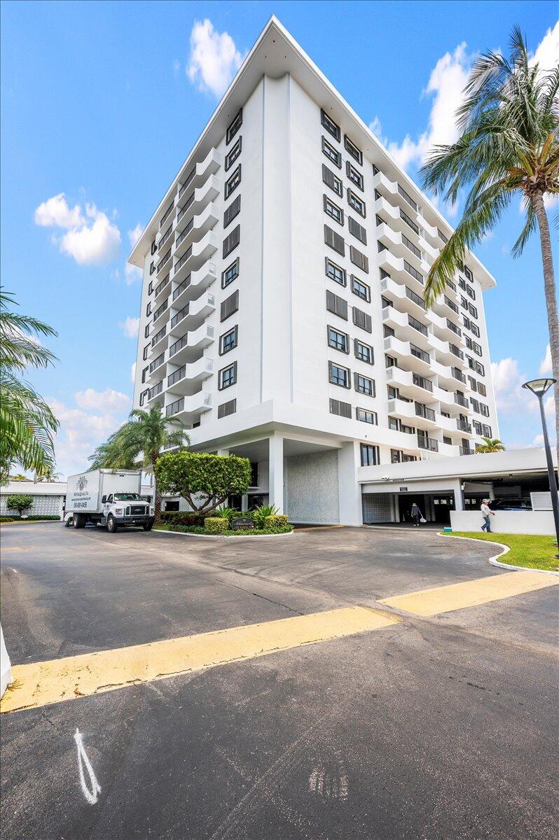 1200 Marine Way, Unit 304 North Palm Beach, FL 33408 - Photo 26 of 31 a front view of a building with swimming pool and large trees