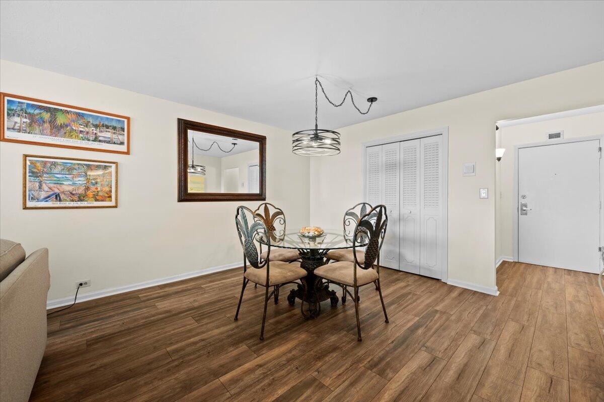 1200 Marine Way, Unit 304 North Palm Beach, FL 33408 - Photo 4 of 31 a view of a dining room with furniture and wooden floor