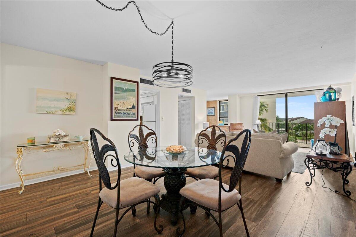 1200 Marine Way, Unit 304 North Palm Beach, FL 33408 - Photo 6 of 31 a view of a dining room with furniture window and wooden floor