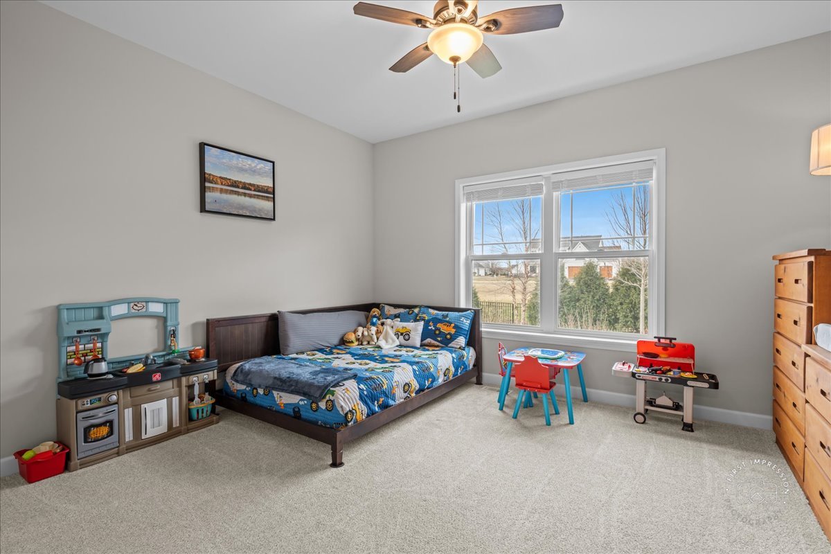 1909 Constitution Street Sycamore, IL 60178 - Photo 15 of 39 a bedroom with a bed and a chandelier