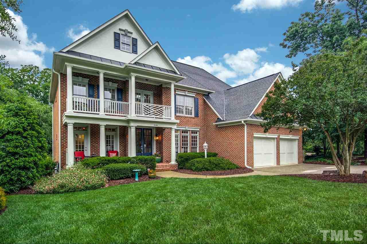 2109 CRIGAN Bluff Drive Cary, NC 27513 - Photo 2 of 30 a front view of a house with a yard and trees