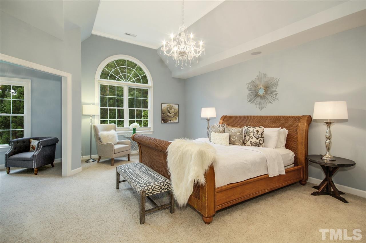 2109 CRIGAN Bluff Drive Cary, NC 27513 - Photo 14 of 30 a bedroom with a bed and a chandelier