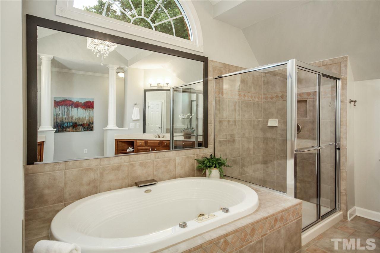 2109 CRIGAN Bluff Drive Cary, NC 27513 - Photo 18 of 30 a bathroom with a bathtub and a shower