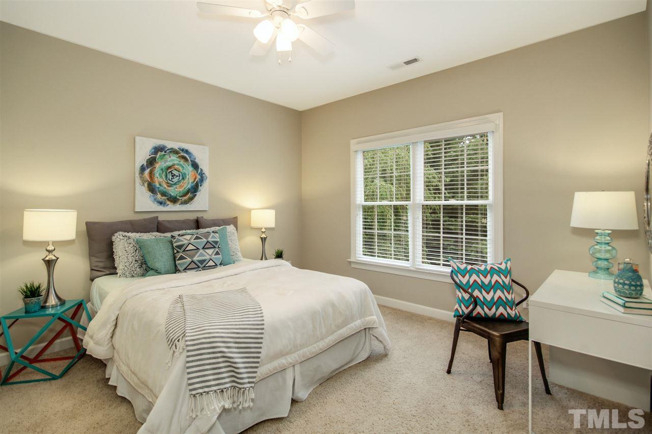 2109 CRIGAN Bluff Drive Cary, NC 27513 - Photo 21 of 30 a bedroom with a bed and a chair