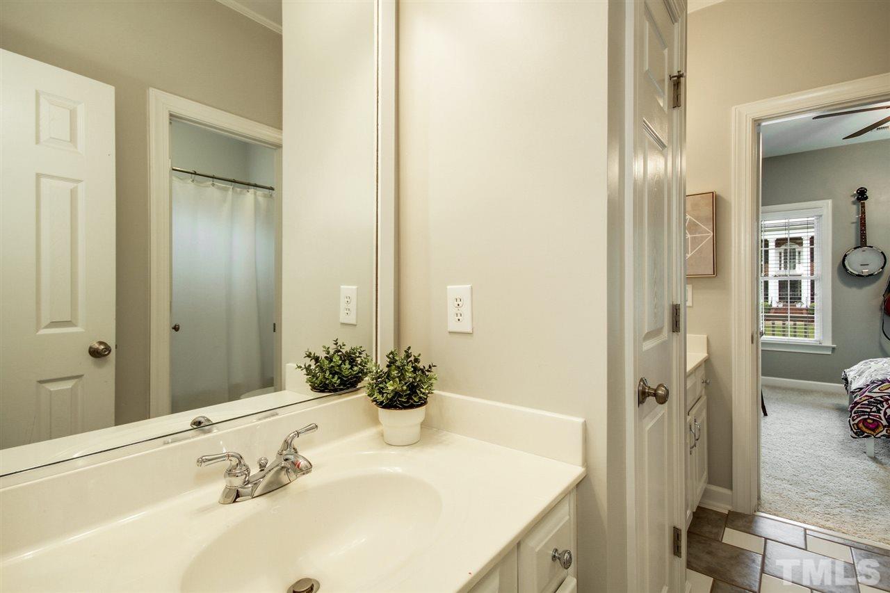 2109 CRIGAN Bluff Drive Cary, NC 27513 - Photo 22 of 30 a bathroom with a granite countertop sink and a mirror