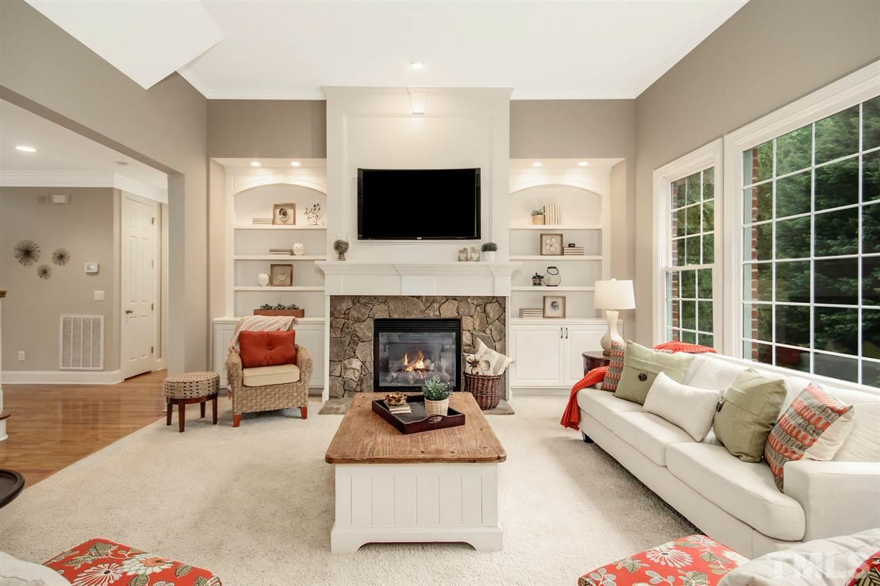 2109 CRIGAN Bluff Drive Cary, NC 27513 - Photo 10 of 30 a living room with furniture a flat screen tv and a fireplace