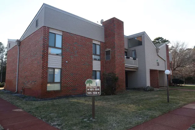 a view of a house with backyard and porch