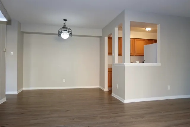 an empty room with wooden floor and a window