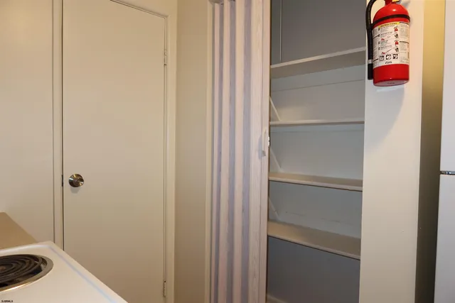 a view of room with window and wooden floor